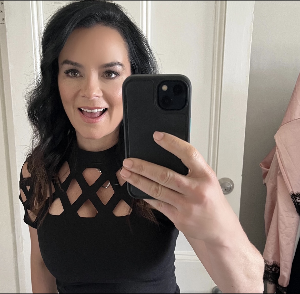 brunette woman in black patterened top