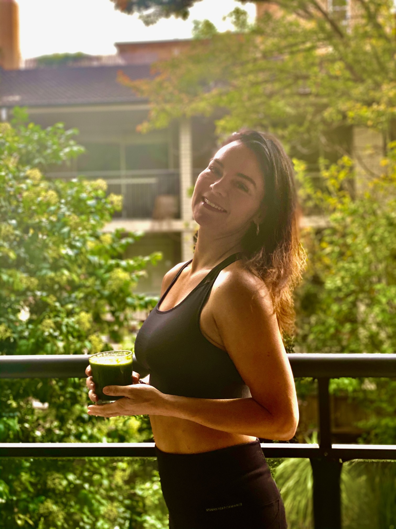 brunette woman with green juice