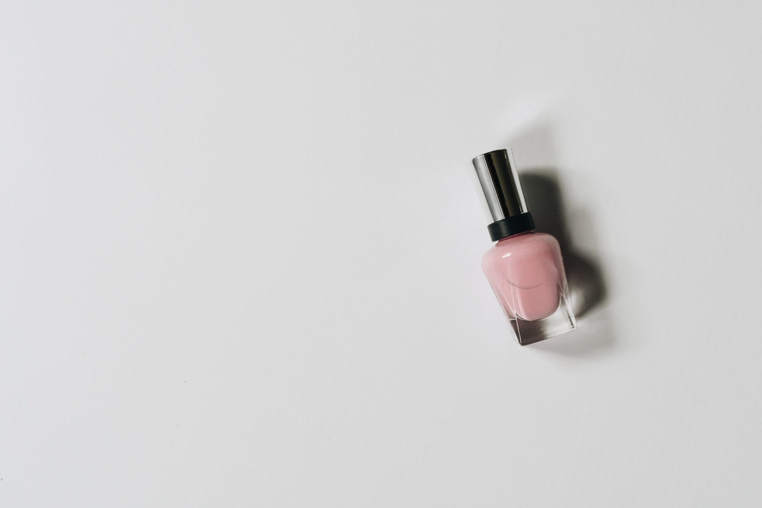 Bottle of nude nail polish on a white background